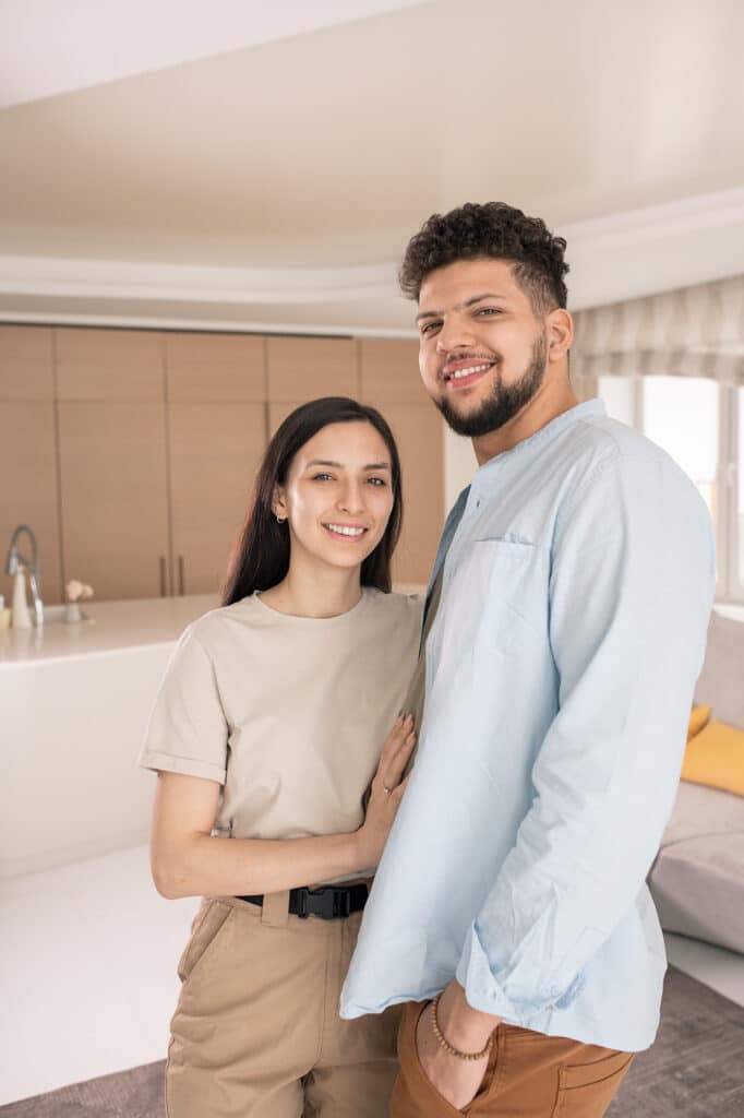 Young couple smiling after renting their first home